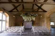 Stunning flower wheels suspended from the rafters of this beautiful Cotswold barn