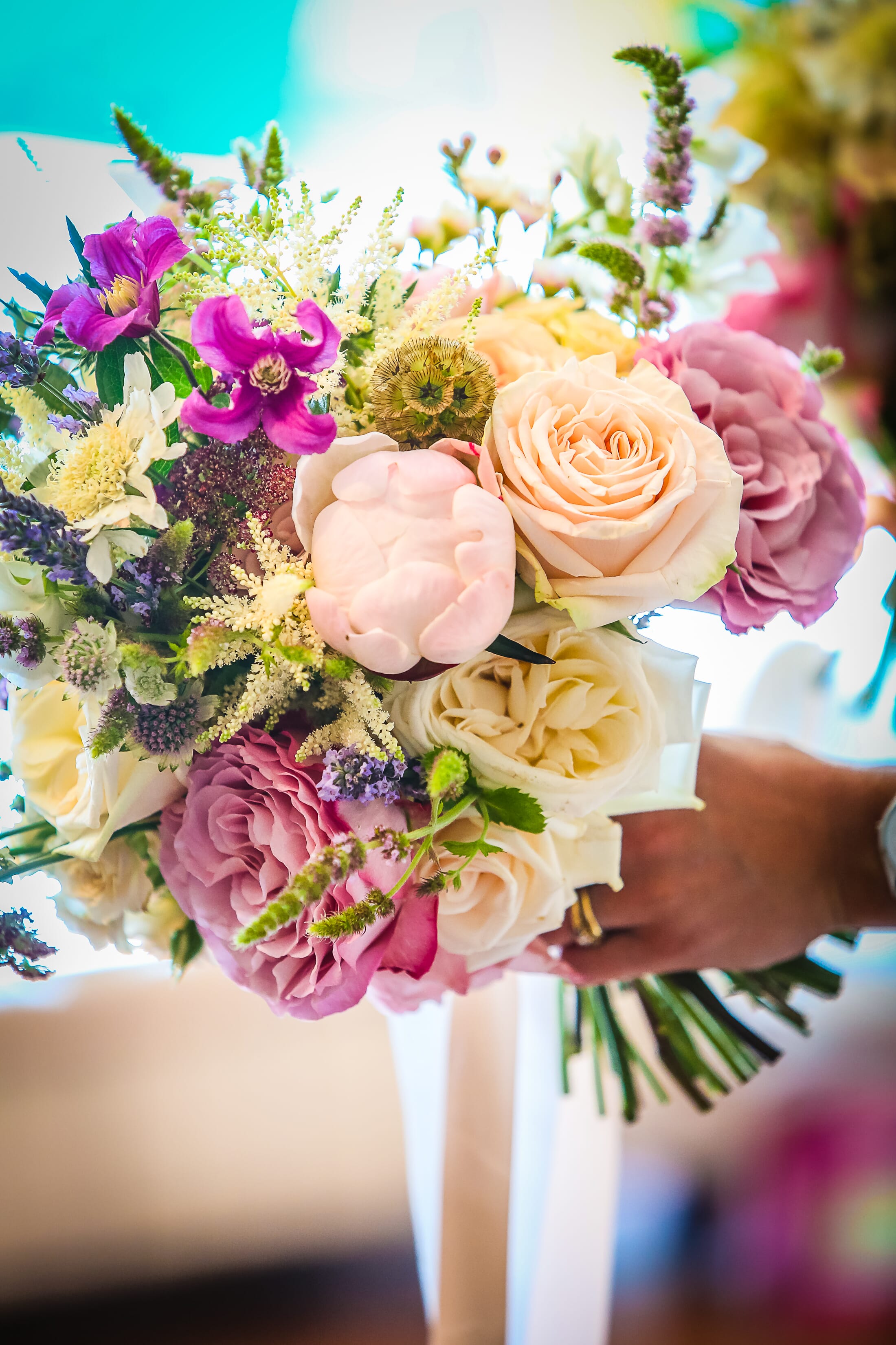 Bride holding a stunning hand tied flower bouquet