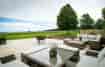 The south facing terrace with casual seating to enjoy the stunning Cotswold view