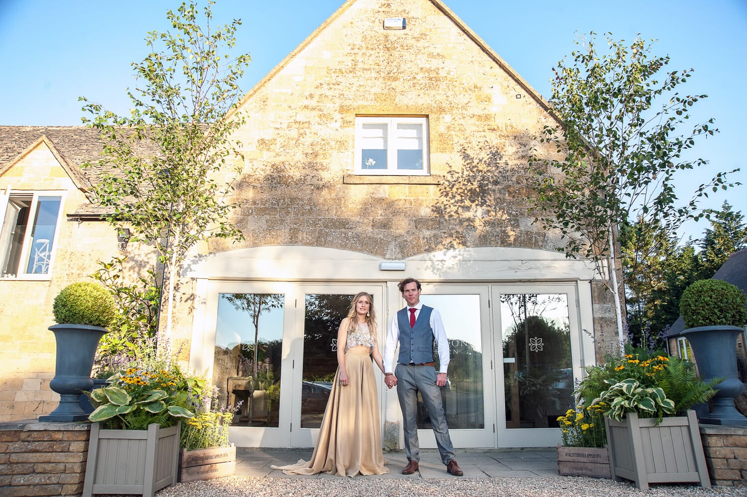 The first bride and groom at the front door of this new Cotswold wedding venue. Photo: Rachel Jones Photography