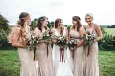 Bride and bridesmaids posing with their wedding bouquets