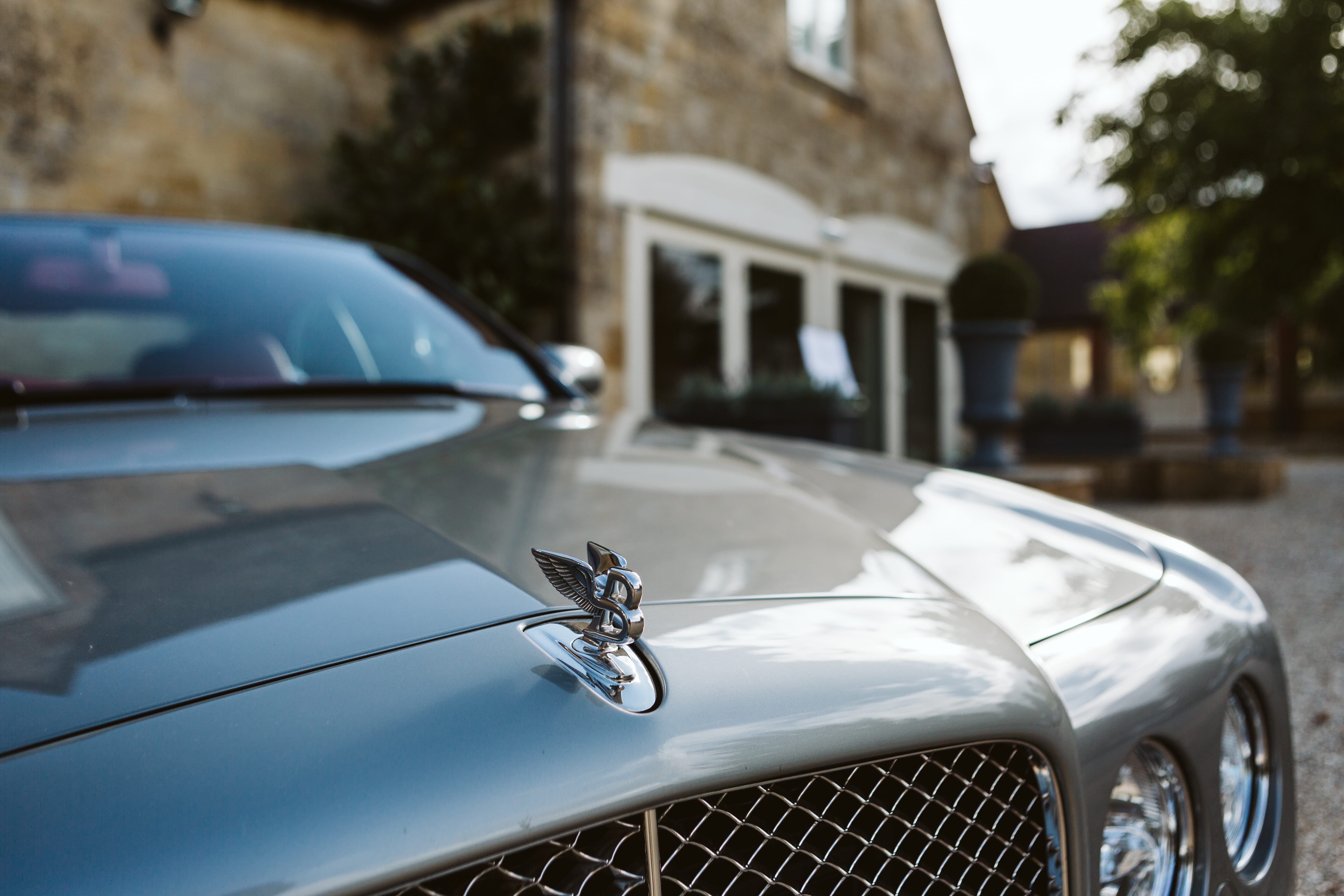 A wedding car parked in front of the barn