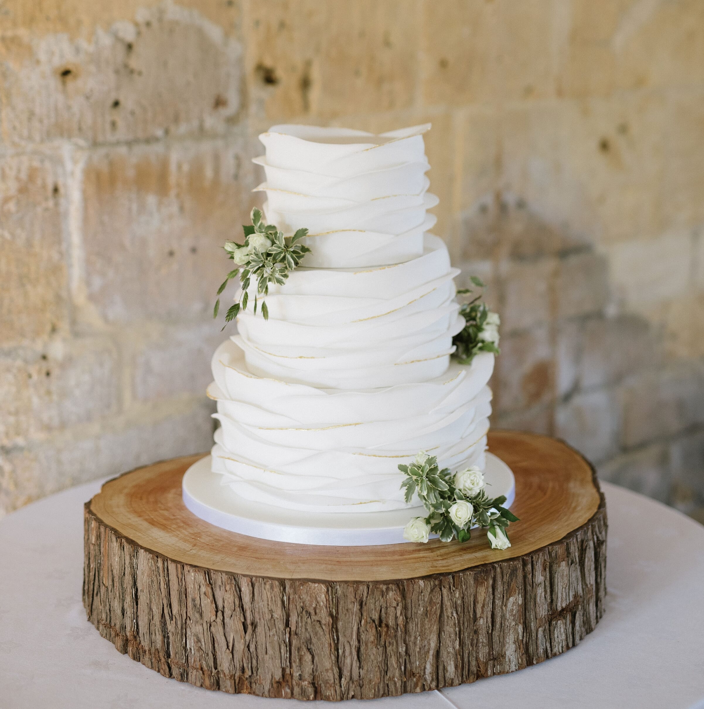 Wedding cake displayed on a log slice stand