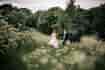 Bride and groom walking in the grounds of the wedding venue. Photography: Katie Hamilton Photography