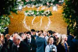 Hanging flower wheels over wedding guests on the dancefloor