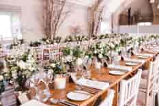 Rustic trestle tables set up for the wedding breakfast